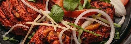Concept: tandoori chicken, dark studio lighting